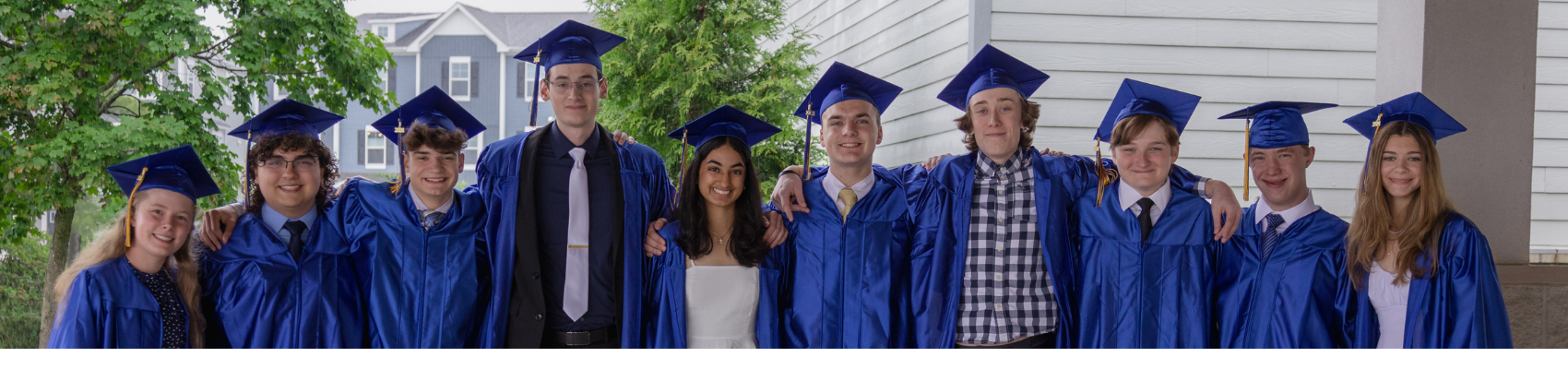 Graduates standing in a row in their caps and gowns